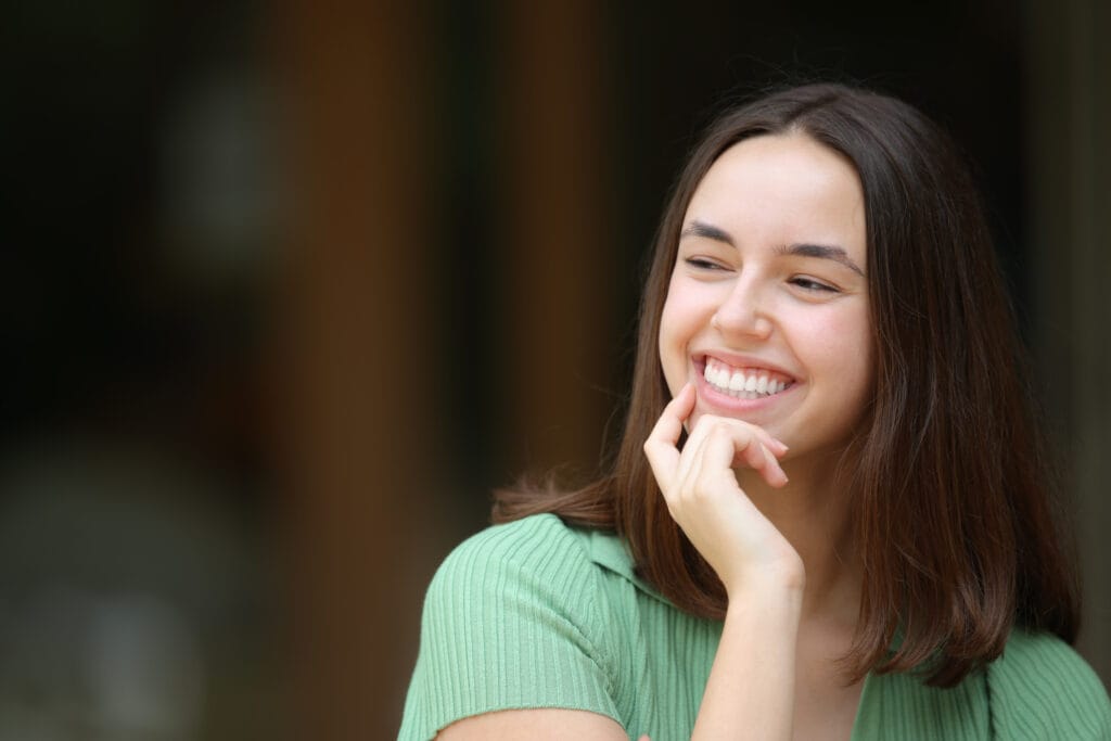 A young woman beams with joy, reflecting the confidence that comes with excellent oral health. - Dentist in South Gate, CA