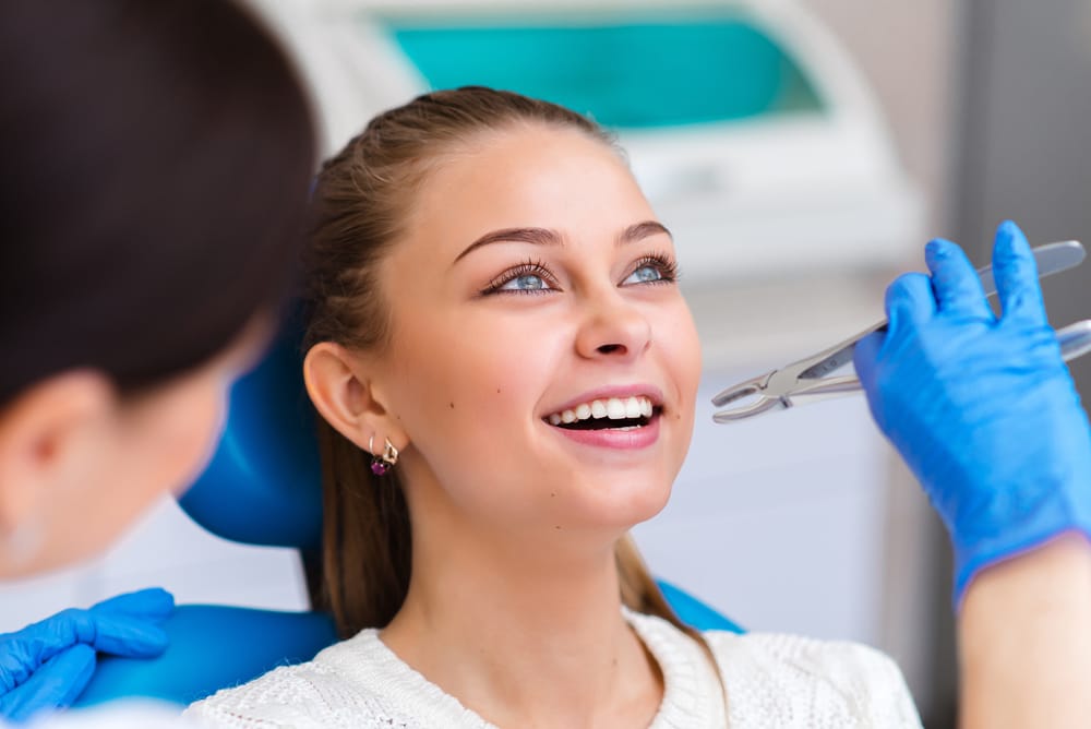 A happy patient enjoys her dental appointment, showing trust and comfort in professional oral care services. - Dentist in South Gate, CA