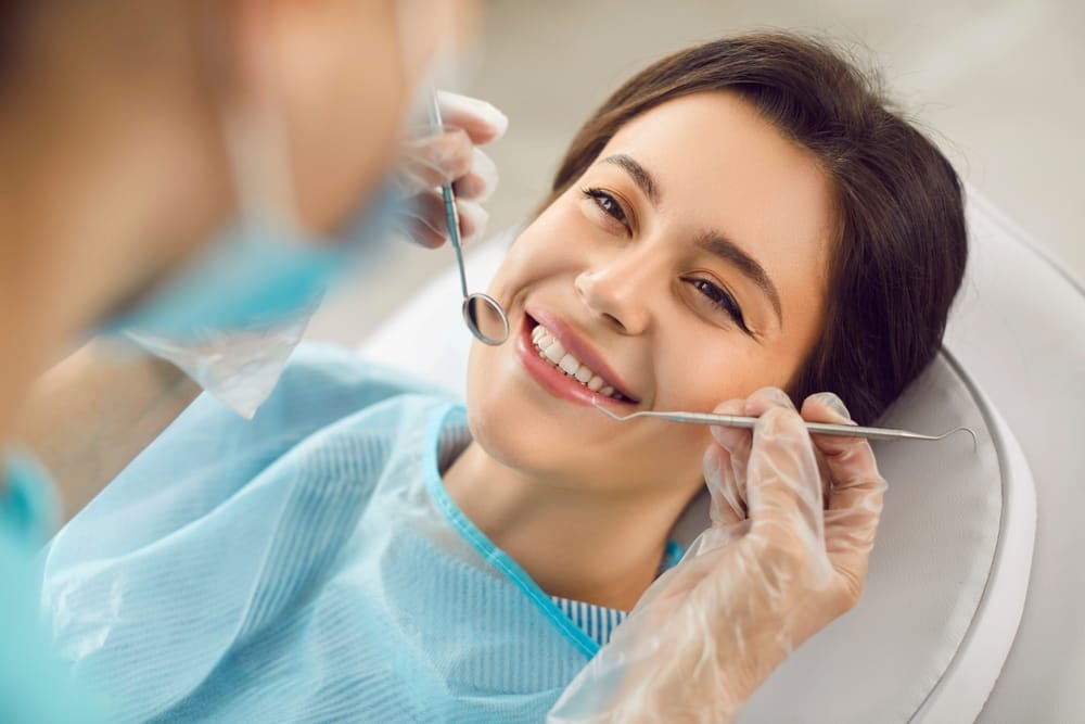 A smiling patient relaxes during her dental procedure, trusting in expert and gentle oral care.