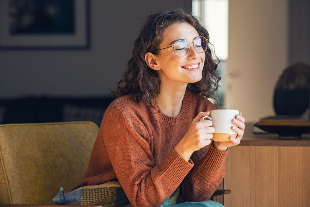 Woman smiling comfortably at home, reflecting confidence and improved smile results achieved with professional orthodontic treatment – Orthodontist Sylmar